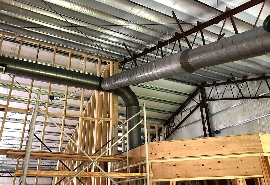 Spiral metal ductwork installed in a commercial building by Collins